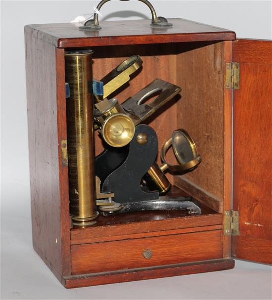 A cased microscope and a cased set of microscope slides